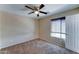 Bedroom with neutral carpet, ceiling fan, and natural light at 10524 W Pima St, Tolleson, AZ 85353