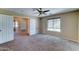 Bedroom featuring neutral walls, carpet flooring, a window, and multiple doorways at 10524 W Pima St, Tolleson, AZ 85353
