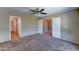 Bedroom featuring neutral walls, carpet flooring, and multiple doorways leading to other rooms at 10524 W Pima St, Tolleson, AZ 85353