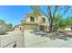 This two-story home has a two-car garage with a well-kept yard at 10524 W Pima St, Tolleson, AZ 85353