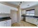 Bright kitchen featuring white cabinets, stainless steel appliances, and tile flooring at 10524 W Pima St, Tolleson, AZ 85353