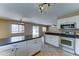 The kitchen features white cabinets, tiled floors, and lots of natural light at 10524 W Pima St, Tolleson, AZ 85353