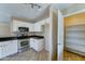 The kitchen features stainless steel appliances and bright white cabinets at 10524 W Pima St, Tolleson, AZ 85353