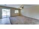 This spacious living room includes a sliding glass door and neutral colors at 10524 W Pima St, Tolleson, AZ 85353