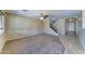 Cozy living room with neutral colors, carpet, and stairs at 10524 W Pima St, Tolleson, AZ 85353