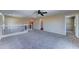 Spacious carpeted loft area with white railings and a view to other rooms at 10524 W Pima St, Tolleson, AZ 85353