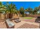 Backyard with a brick-paved patio, integrated seating, a cozy fire pit, and desert landscaping at 11826 W Villa Hermosa Ln, Sun City, AZ 85373