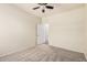 The carpeted bedroom is freshly painted in neutral colors and has a ceiling fan at 11826 W Villa Hermosa Ln, Sun City, AZ 85373