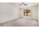 Spacious bedroom with plush carpeting, a ceiling fan, and a large window at 11826 W Villa Hermosa Ln, Sun City, AZ 85373