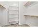 Bright walk-in closet with built in shelves and clothes rods at 11826 W Villa Hermosa Ln, Sun City, AZ 85373