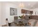 Cozy dining area adjacent to the kitchen, featuring a glass table and modern light fixture at 11826 W Villa Hermosa Ln, Sun City, AZ 85373