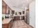 Well-equipped kitchen featuring stainless steel appliances, wooden cabinets, and tiled flooring at 11826 W Villa Hermosa Ln, Sun City, AZ 85373