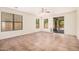 Spacious living room with tile floors, natural lighting, and sliding glass door access to outdoor area at 11826 W Villa Hermosa Ln, Sun City, AZ 85373