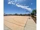 Community basketball court featuring clear blue sky, decorative landscaping, and power lines at 12109 W Tether Trl, Peoria, AZ 85383