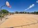 Community basketball court featuring clear blue sky, decorative landscaping, and benches at 12109 W Tether Trl, Peoria, AZ 85383