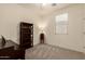 Carpeted bedroom with a bookcase, piano, and a bright window at 12109 W Tether Trl, Peoria, AZ 85383