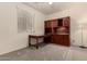 Cozy bedroom featuring a built-in desk and wall unit, perfect for work or study at 12109 W Tether Trl, Peoria, AZ 85383