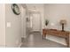 Inviting entryway with tile floors, neutral paint, wood console table, and decorative wall art at 12109 W Tether Trl, Peoria, AZ 85383