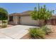 Charming single-story home featuring a two-car garage and desert landscaping at 12109 W Tether Trl, Peoria, AZ 85383