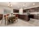 Open-concept kitchen with a center island, dark cabinets, granite countertops, and stainless steel appliances at 12109 W Tether Trl, Peoria, AZ 85383