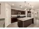 Open kitchen with a center island, dark cabinets, granite countertops, and stainless steel appliances at 12109 W Tether Trl, Peoria, AZ 85383