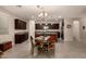 Spacious eat-in kitchen with a center island, dark cabinets, granite countertops, and stainless steel appliances at 12109 W Tether Trl, Peoria, AZ 85383