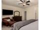 Comfortable bedroom with a dresser, leather chair, a TV, and a ceiling fan at 12109 W Tether Trl, Peoria, AZ 85383