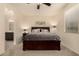 Comfortable bedroom with a queen-sized bed, bedside tables, and a view to the ensuite bathroom at 12109 W Tether Trl, Peoria, AZ 85383