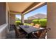 Relaxing covered patio with tile table and chairs for outdoor dining and entertaining at 12109 W Tether Trl, Peoria, AZ 85383