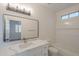 Bathroom featuring a vanity with a white countertop, modern faucet and lighting, with a framed mirror at 125 N 22Nd Pl # 5, Mesa, AZ 85213