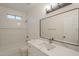 Bathroom featuring a vanity with a white countertop, modern faucet and lighting, with a framed mirror at 125 N 22Nd Pl # 5, Mesa, AZ 85213