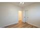 Bedroom featuring light colored walls, wood floor, closet with sliding doors, and access to a doorway at 125 N 22Nd Pl # 5, Mesa, AZ 85213