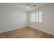 Comfortable bedroom featuring neutral walls, ceiling fan, and plantation shutters at 125 N 22Nd Pl # 5, Mesa, AZ 85213