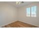 Bedroom featuring light colored walls, wood floor, a window with shuttered blinds and a ceiling fan at 125 N 22Nd Pl # 5, Mesa, AZ 85213