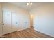 Bedroom featuring light colored walls, wood floor, closet with sliding doors, and access to a doorway at 125 N 22Nd Pl # 5, Mesa, AZ 85213