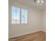 Bright bedroom featuring a window with shuttered blinds allowing ample natural light onto the wood floor at 125 N 22Nd Pl # 5, Mesa, AZ 85213