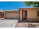 Inviting front exterior with a two-car garage, desert landscaping, and covered entryway at 125 N 22Nd Pl # 5, Mesa, AZ 85213