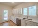 Bright and functional kitchen with modern appliances, white cabinets, and outdoor access at 125 N 22Nd Pl # 5, Mesa, AZ 85213