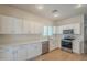 Modern kitchen featuring white cabinetry, stainless steel appliances, and stone countertops at 125 N 22Nd Pl # 5, Mesa, AZ 85213
