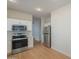 Kitchen with stainless steel appliances, light wood floors, and white cabinets at 125 N 22Nd Pl # 5, Mesa, AZ 85213