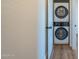 Laundry area featuring a stacked washer and dryer combo behind a doorway at 125 N 22Nd Pl # 5, Mesa, AZ 85213