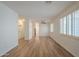 Bright living room featuring wood floors and white plantation shutters on the windows at 125 N 22Nd Pl # 5, Mesa, AZ 85213