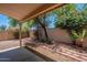 Covered outdoor patio with stone pathway and desert landscaping at 125 N 22Nd Pl # 5, Mesa, AZ 85213