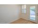 Well-lit room with plantation shutters, wood floors and access to outside at 125 N 22Nd Pl # 5, Mesa, AZ 85213