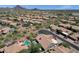 An aerial view showcases an upscale desert community with luxury homes and a community pool at 12638 E Cortez Dr, Scottsdale, AZ 85259