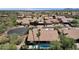 Birds eye view of a beautiful desert home with pool and green landscaping and mountain views at 12638 E Cortez Dr, Scottsdale, AZ 85259