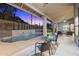 Covered patio with seating area adjacent to a beautiful pool, offering a serene outdoor living space at 12638 E Cortez Dr, Scottsdale, AZ 85259