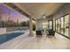 Inviting covered patio with ceiling fan and elegant columns, overlooking a refreshing pool and outdoor seating area at 12638 E Cortez Dr, Scottsdale, AZ 85259
