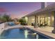 Beautiful backyard pool featuring water fountains, poolside lounge chairs, and covered patio with outdoor furniture at 12638 E Cortez Dr, Scottsdale, AZ 85259