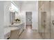Elegant bathroom with a marble countertop, double sinks, and a glass-enclosed shower at 12638 E Cortez Dr, Scottsdale, AZ 85259